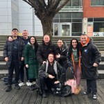 Recovery Group About Us page - a group of people stood next to a tree, outside a building